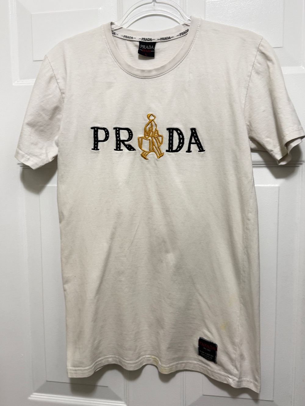 Authentic Prada White Crewneck T-Shirt with Black and red Logo. Used conditions